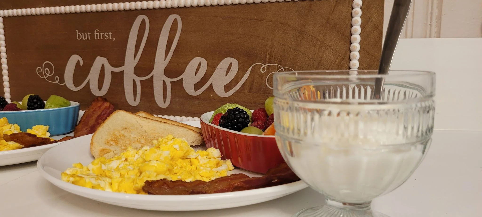 Coffee sign with milk and eggs and bacon and fruit